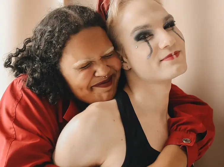 LGBTQ couple embracing in affirming therapy context representing inclusive mental health support