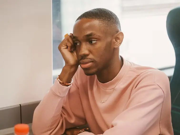 Young professional looking fatigued at desk representing millennial burnout and stress